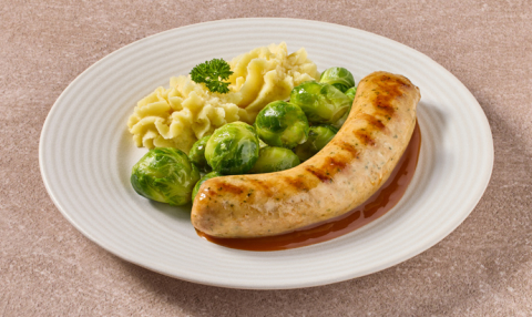 Kruidige braadworst in jus met spruitjes en aardappelpuree